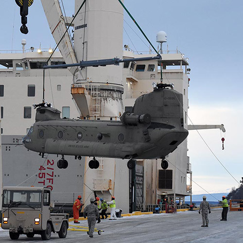 Chinook being loaded onto a ship