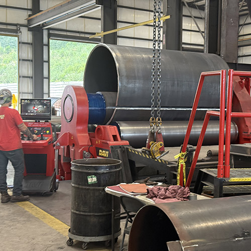 Steel plate is rolled into 10-foot-long sections.