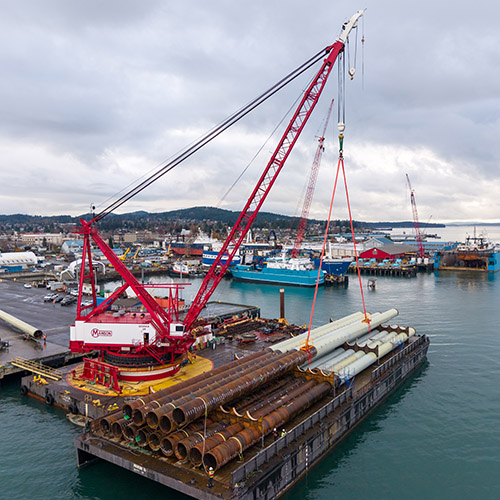 Loading finished piles in Anacortes, WA for transport up to Port of Alaska.