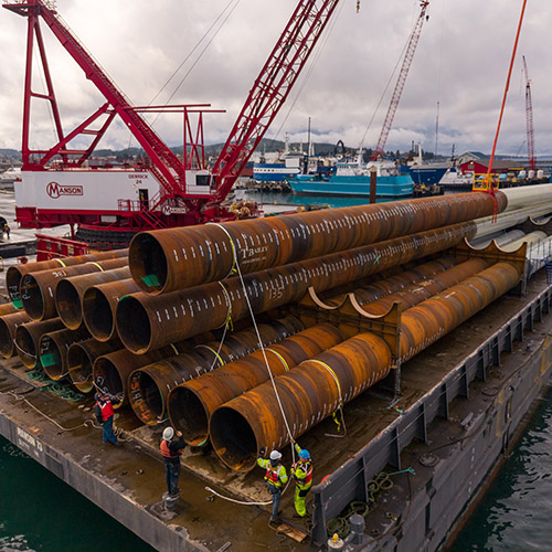 Inspecting finished piles after loading on the barge for transport.